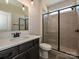 Bathroom featuring a single vanity, framed mirror, and walk-in shower with gray tiles at 2211 Camber Dr # Cwo0103, Gastonia, NC 28054