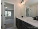 Bathroom featuring double sink vanity, framed mirror, and view into bedroom at 2211 Camber Dr # Cwo0103, Gastonia, NC 28054