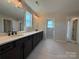 Bathroom featuring a dual sink vanity, large mirrors, and updated finishes at 2211 Camber Dr # Cwo0103, Gastonia, NC 28054