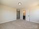 Bedroom featuring neutral carpet, overhead light fixture, and doorway to a bathroom at 2211 Camber Dr # Cwo0103, Gastonia, NC 28054