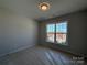 Bright bedroom with large window featuring a ceiling light and neutral walls at 2211 Camber Dr # Cwo0103, Gastonia, NC 28054