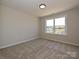 Bright bedroom featuring large window and neutral carpet, offering a serene retreat at 2211 Camber Dr # Cwo0103, Gastonia, NC 28054