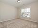 Cozy bedroom featuring a large window, neutral carpet, and a ceiling light at 2211 Camber Dr # Cwo0103, Gastonia, NC 28054