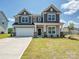 Beautiful two-story home featuring a two-car garage and a well-manicured lawn at 2211 Camber Dr # Cwo0103, Gastonia, NC 28054