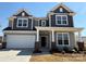 Charming two-story home with gray siding, white trim, brick accents, and a welcoming front porch at 2211 Camber Dr # Cwo0103, Gastonia, NC 28054