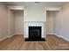 Cozy living room featuring hardwood floors, a central fireplace, and built-in decorative alcoves at 2211 Camber Dr # Cwo0103, Gastonia, NC 28054