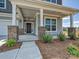 Inviting home entrance with a covered porch, brick pillars, and tasteful landscaping at 2211 Camber Dr # Cwo0103, Gastonia, NC 28054