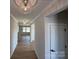 Bright hallway featuring stylish light fixtures, wood floors, and views into the home's living spaces at 2211 Camber Dr # Cwo0103, Gastonia, NC 28054