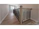 Hallway featuring wood flooring and a staircase with modern black metal railing at 2211 Camber Dr # Cwo0103, Gastonia, NC 28054