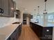 Modern kitchen showcasing dark cabinets, a large island with pendant lighting, and stainless steel appliances at 2211 Camber Dr # Cwo0103, Gastonia, NC 28054