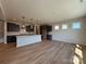 Open concept kitchen and living area with dark cabinets, quartz countertops, and natural light from three windows at 2211 Camber Dr # Cwo0103, Gastonia, NC 28054