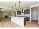A bright kitchen features an island with pendant lights, stainless appliances, and ample counter space at 2211 Camber Dr # Cwo0103, Gastonia, NC 28054