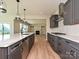 This kitchen offers stainless appliances, sleek gray cabinets, and a large island with a view to the living area at 2211 Camber Dr # Cwo0103, Gastonia, NC 28054