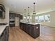 Modern kitchen features a large island with pendant lighting and stainless steel appliances at 2211 Camber Dr # Cwo0103, Gastonia, NC 28054