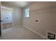 Tiled laundry room with window, utility connections and wire shelving for organized storage at 2211 Camber Dr # Cwo0103, Gastonia, NC 28054