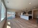 Bright open living area with hardwood floors, large windows, and access to the kitchen at 2211 Camber Dr # Cwo0103, Gastonia, NC 28054