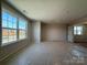 Spacious living room with large windows providing ample natural light and street view at 2211 Camber Dr # Cwo0103, Gastonia, NC 28054