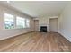 Spacious living room featuring hardwood floors and a fireplace is lit by many windows at 2211 Camber Dr # Cwo0103, Gastonia, NC 28054