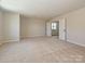 Large carpeted living room with an open doorway for easy access and great natural light at 2211 Camber Dr # Cwo0103, Gastonia, NC 28054