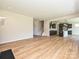 Open living area with hardwood floors leads to the kitchen and staircase at 2211 Camber Dr # Cwo0103, Gastonia, NC 28054