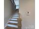 Stairway featuring a light wood handrail and white risers at 2211 Camber Dr # Cwo0103, Gastonia, NC 28054