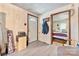 Inviting entryway with coat rack, leading to a cozy bedroom; flooring and wood paneling add rustic charm at 225 Institute St, Mooresville, NC 28115
