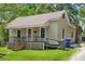 Quaint single-story home showcasing a classic design with a small front porch and lush green lawn at 225 Institute St, Mooresville, NC 28115