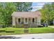 Charming single-story home featuring a cozy front porch, well-maintained lawn, and a welcoming facade at 225 Institute St, Mooresville, NC 28115