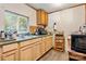 Functional kitchen featuring a double sink, wood cabinets, and modern appliances, perfect for home-cooked meals at 225 Institute St, Mooresville, NC 28115