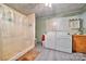 Functional laundry room with a shower, washer, dryer, and ample space for cleaning tasks at 225 Institute St, Mooresville, NC 28115