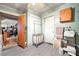 Well-organized laundry area featuring ample shelving, hanging racks, and convenient access to other rooms at 225 Institute St, Mooresville, NC 28115