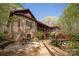 The Backyard features mature trees, brick patio and outdoor seating area at 225 Riverton Rd, Weddington, NC 28104