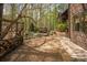 Picturesque backyard featuring mature trees and shrubs, a wood fence, and wood pile at 225 Riverton Rd, Weddington, NC 28104