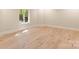 An Empty bedroom featuring hardwood floors, and a window at 225 Riverton Rd, Weddington, NC 28104