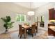 Bright breakfast nook featuring a table for four, with natural lighting and access to the patio at 225 Riverton Rd, Weddington, NC 28104