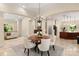 An airy dining room features a round table with seating for six, with natural light at 225 Riverton Rd, Weddington, NC 28104