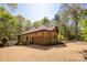 View of the home's exterior with a brick facade and a gravel driveway at 225 Riverton Rd, Weddington, NC 28104