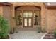 Elegant brick entryway with a double front door, flanked by decorative plants and stone accents at 225 Riverton Rd, Weddington, NC 28104