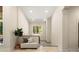 Inviting hallway with a cozy bench, decorative pillows, and a large window showcasing natural light and outdoor scenery at 225 Riverton Rd, Weddington, NC 28104