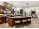 Spacious kitchen with large island, granite counters, stainless steel appliances, and seamless flow to dining area at 225 Riverton Rd, Weddington, NC 28104