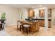 Stylish kitchen featuring a central island with bar seating, dark countertops, and custom cabinetry for ample storage at 225 Riverton Rd, Weddington, NC 28104