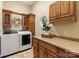 Bright laundry room featuring cabinets, counter space, and a modern washer and dryer at 225 Riverton Rd, Weddington, NC 28104