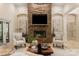Cozy living room with a stone fireplace, elegant seating, and soft, natural lighting at 225 Riverton Rd, Weddington, NC 28104