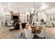 Open-concept living room with a fireplace, dining area, and plenty of natural light at 225 Riverton Rd, Weddington, NC 28104