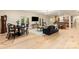 Open-concept living room with hardwood floors, comfortable seating, and access to outdoor patios, perfect for entertaining at 225 Riverton Rd, Weddington, NC 28104