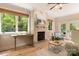 Cozy living room featuring a stone fireplace, hardwood floors, and an abundance of natural light at 225 Riverton Rd, Weddington, NC 28104
