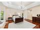 Spacious main bedroom with chandelier lighting, wood floors, area rug, and access to exterior at 225 Riverton Rd, Weddington, NC 28104