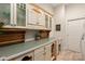 Well-organized pantry with ample cabinet space, decorative accents, and a convenient sink for easy cleanup at 225 Riverton Rd, Weddington, NC 28104