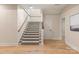 Staircase featuring carpeted steps, wood railing, and natural light, leading to a bright and airy upper level at 225 Riverton Rd, Weddington, NC 28104