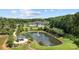 Scenic aerial view of the community featuring a pond, clubhouse, pool, and lush green surroundings at 3288 Sherman Dr, Lancaster, SC 29720